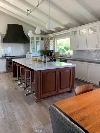 a kitchen with stainless steel appliances granite countertop a sink and cabinets