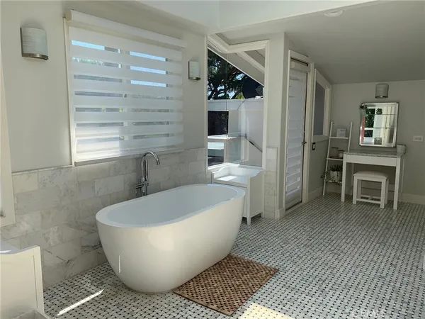 a bathroom with a bathtub and shower