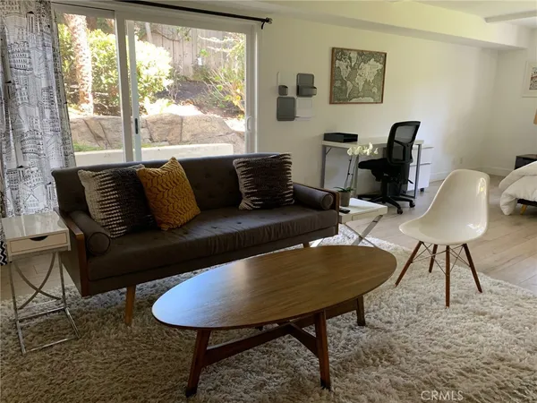 a living room with furniture lamp and window