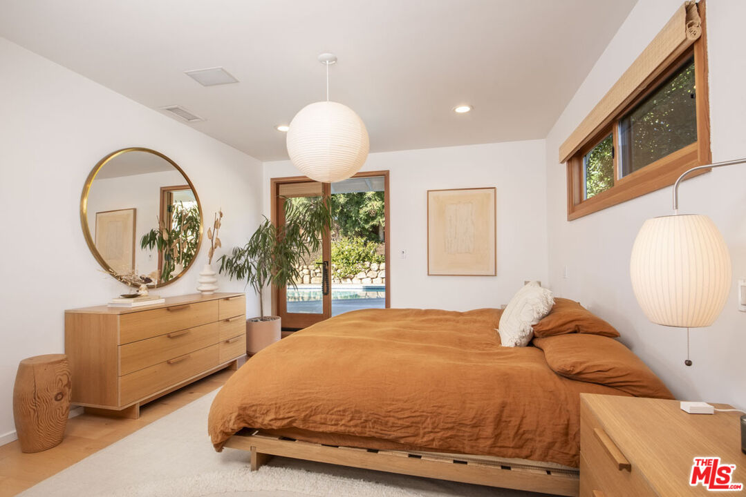 530 Pleasant Avenue Ojai, CA 93023 - Photo 12 of 29 a bedroom with a bed a mirror on dresser and a large mirror