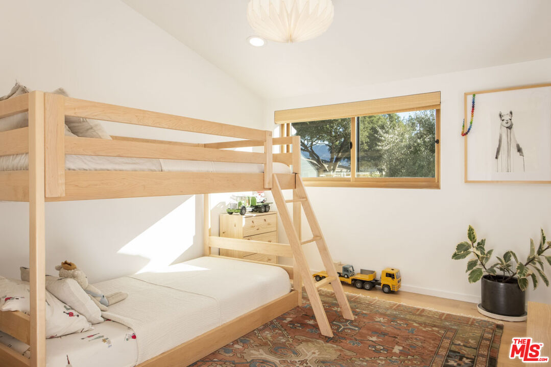 530 Pleasant Avenue Ojai, CA 93023 - Photo 16 of 29 a bedroom with a bed and wooden floor