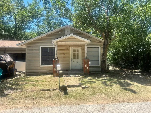 a house with trees in the background