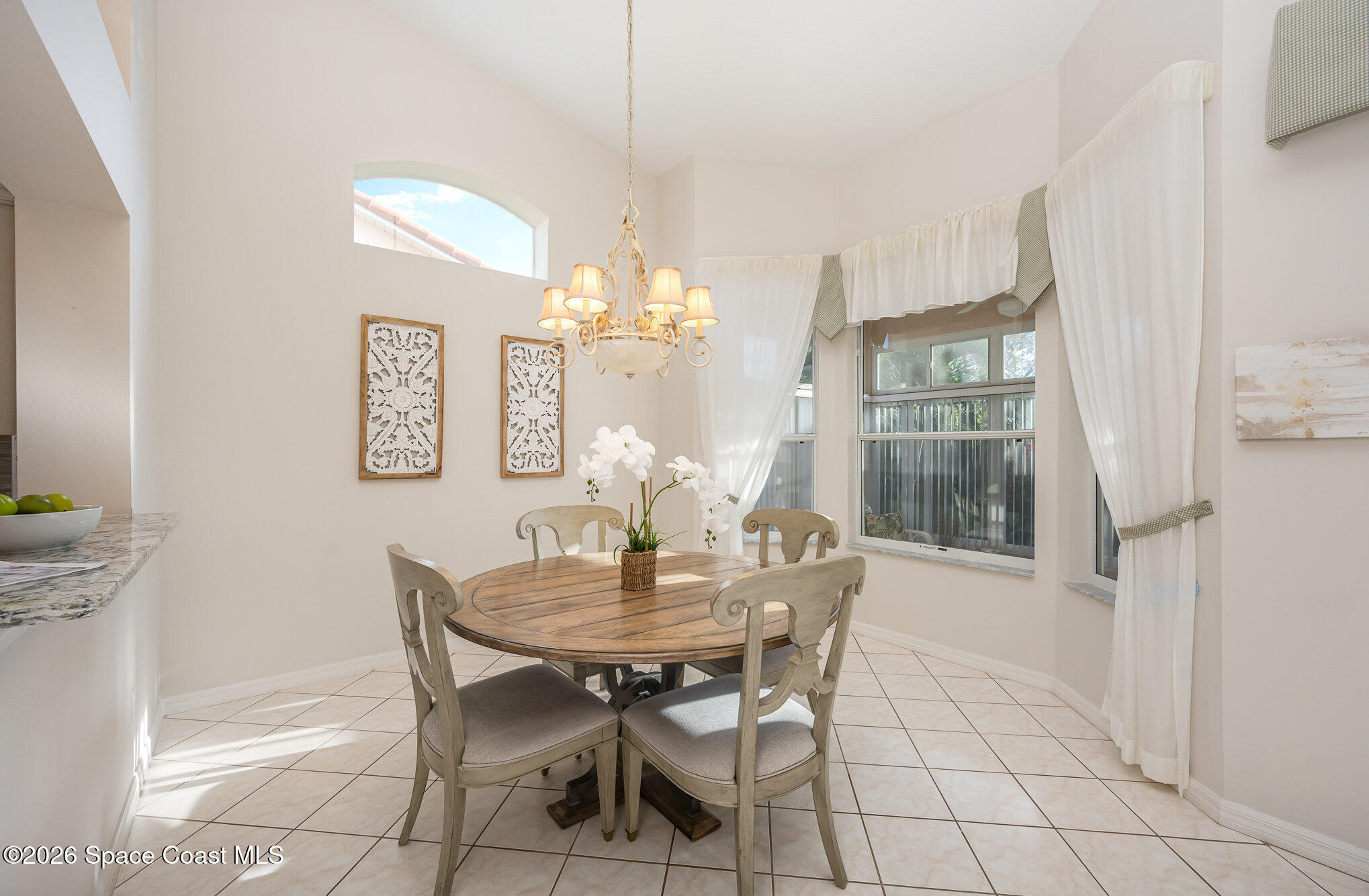 518 Renaissance Avenue Melbourne, FL 32940 - Photo 11 of 26 a view of a dining room with furniture and chandelier