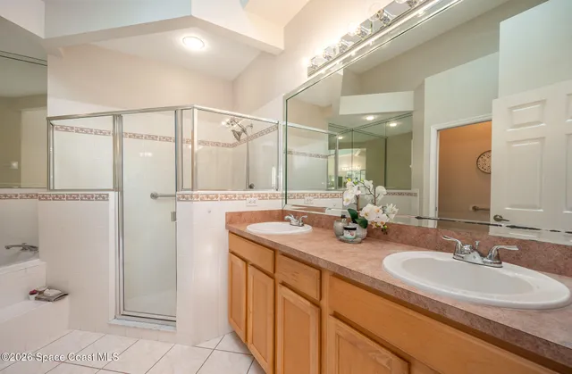 a bathroom with a double vanity sink and a mirror