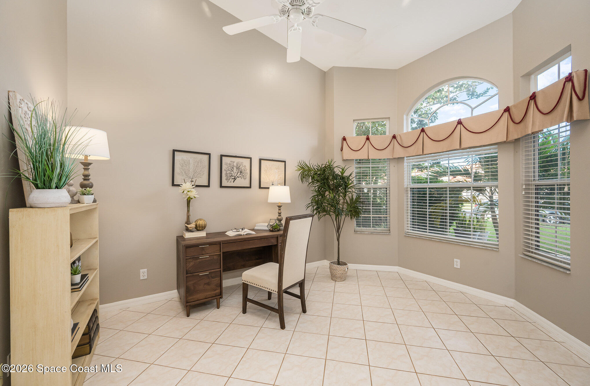 518 Renaissance Avenue Melbourne, FL 32940 - Photo 16 of 26 a view of a workspace with furniture and a chandelier