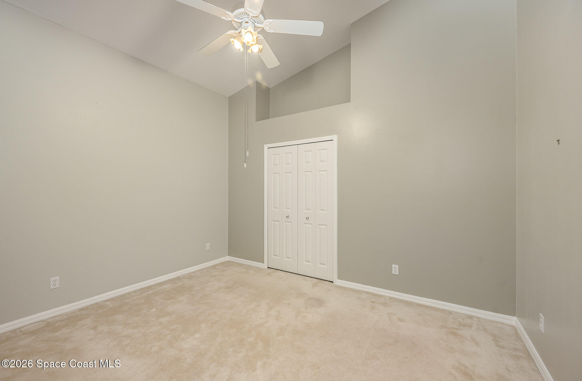 518 Renaissance Avenue Melbourne, FL 32940 - Photo 19 of 26 an empty room with a chandelier fan and closet