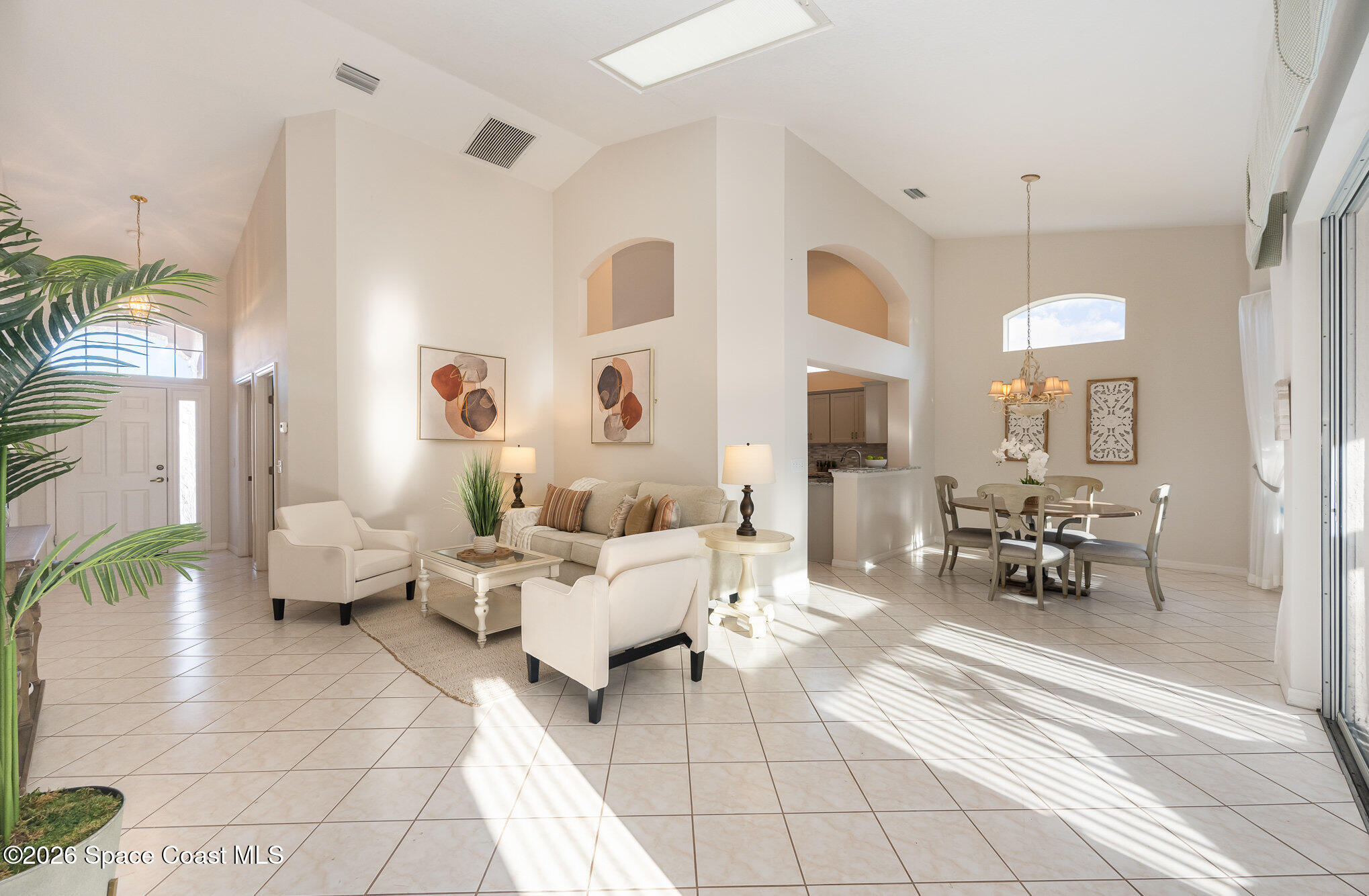 518 Renaissance Avenue Melbourne, FL 32940 - Photo 4 of 26 a living room with fireplace furniture and a chandelier