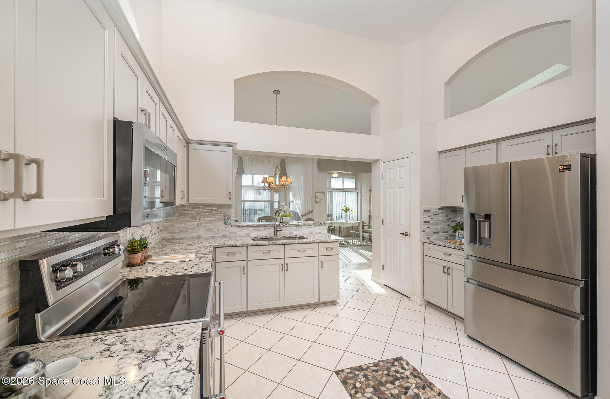 518 Renaissance Avenue Melbourne, FL 32940 - Photo 6 of 26 a kitchen with a sink stove and refrigerator