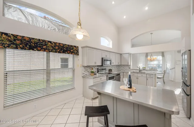 a kitchen with a sink cabinets and window