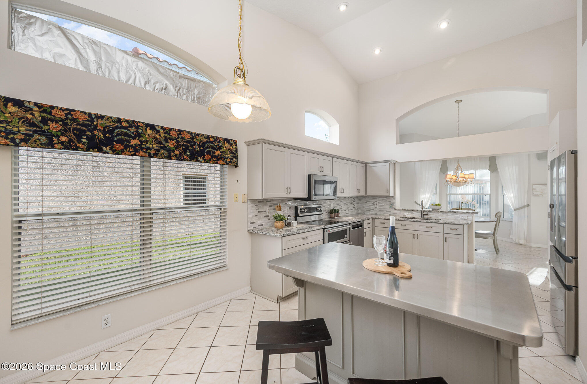 518 Renaissance Avenue Melbourne, FL 32940 - Photo 9 of 26 a kitchen with a sink cabinets and window