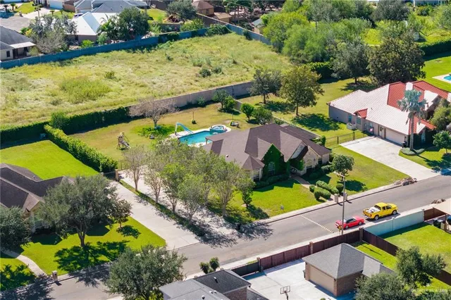 an aerial view of residential houses with outdoor space