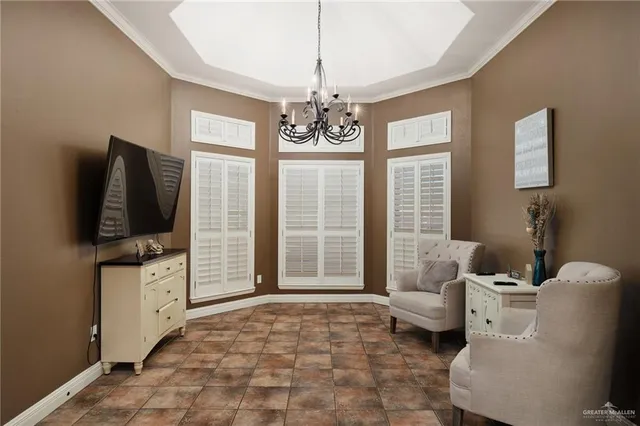 a living room with furniture a flat screen tv and large windows
