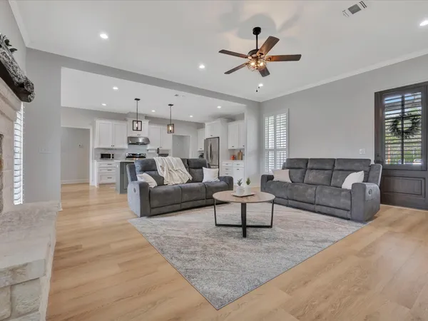 a living room with furniture and a chandelier