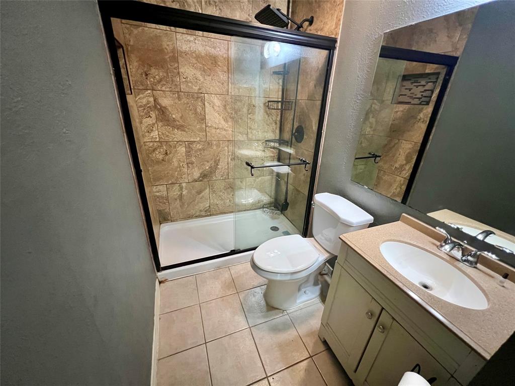 2805 Scott Mill Road Carrollton, TX 75007 - Photo 15 of 19 a bathroom with a toilet and a shower