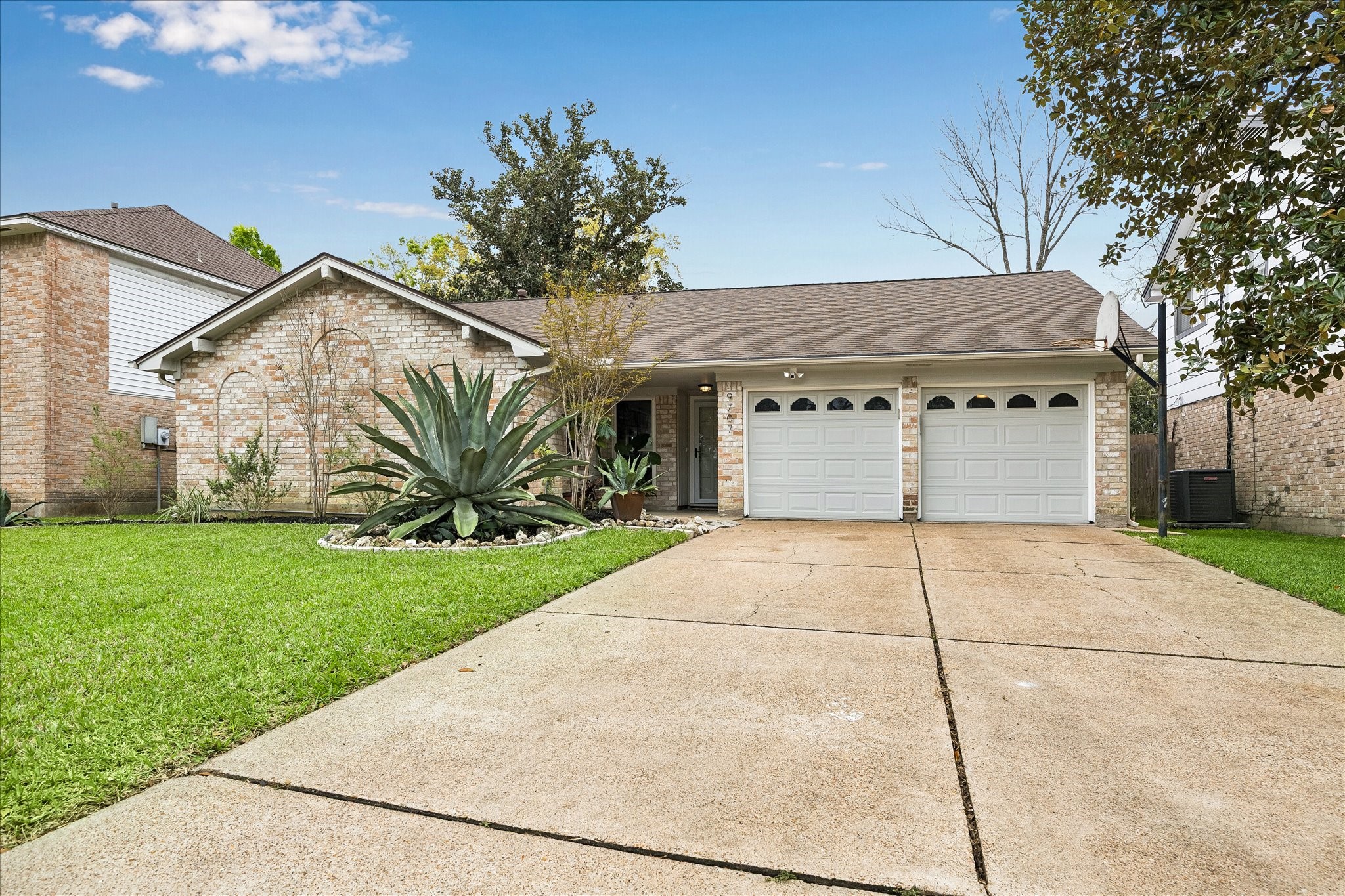 9707 Lawngate Drive Houston, TX 77080 - Photo 2 of 16 a front view of a house with garden
