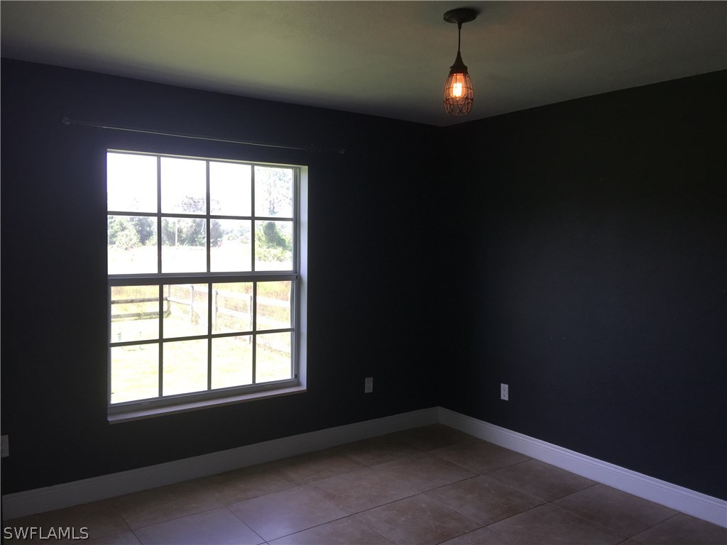 4015 36th Street Southwest Lehigh Acres, FL 33976 - Photo 13 of 23 a view of an empty room with a window