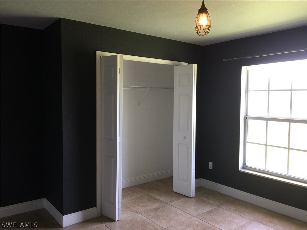 4015 36th Street Southwest Lehigh Acres, FL 33976 - Photo 14 of 23 a view of an empty room with a window