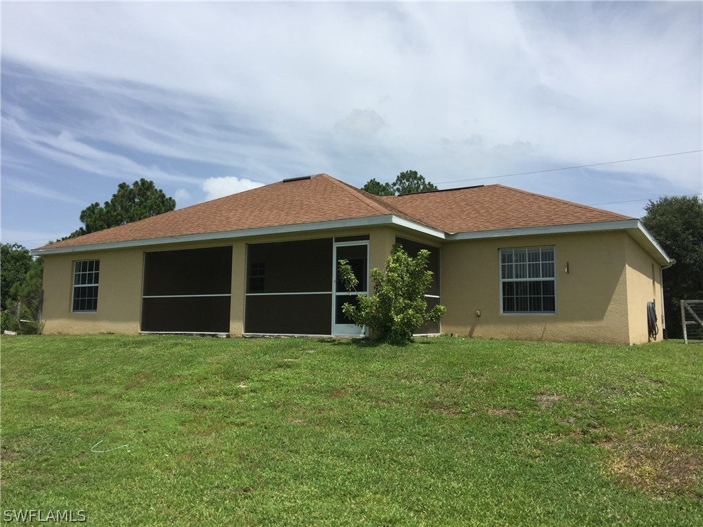 4015 36th Street Southwest Lehigh Acres, FL 33976 - Photo 20 of 23 a front view of a house with a yard