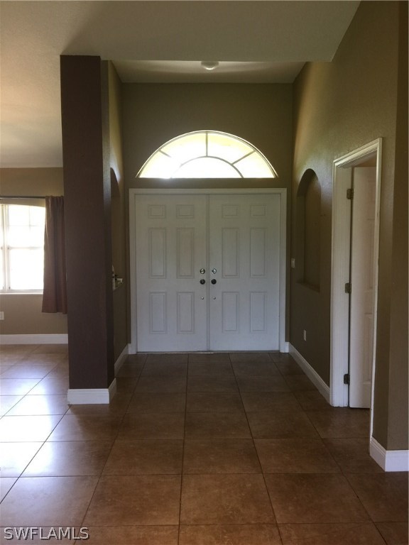 4015 36th Street Southwest Lehigh Acres, FL 33976 - Photo 4 of 23 a view of a hallway with wooden door and a bathroom