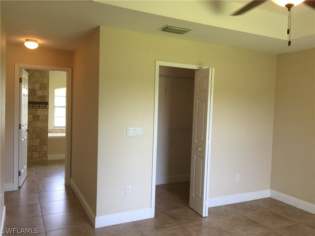 4015 36th Street Southwest Lehigh Acres, FL 33976 - Photo 9 of 23 a view of a hallway with wooden floor