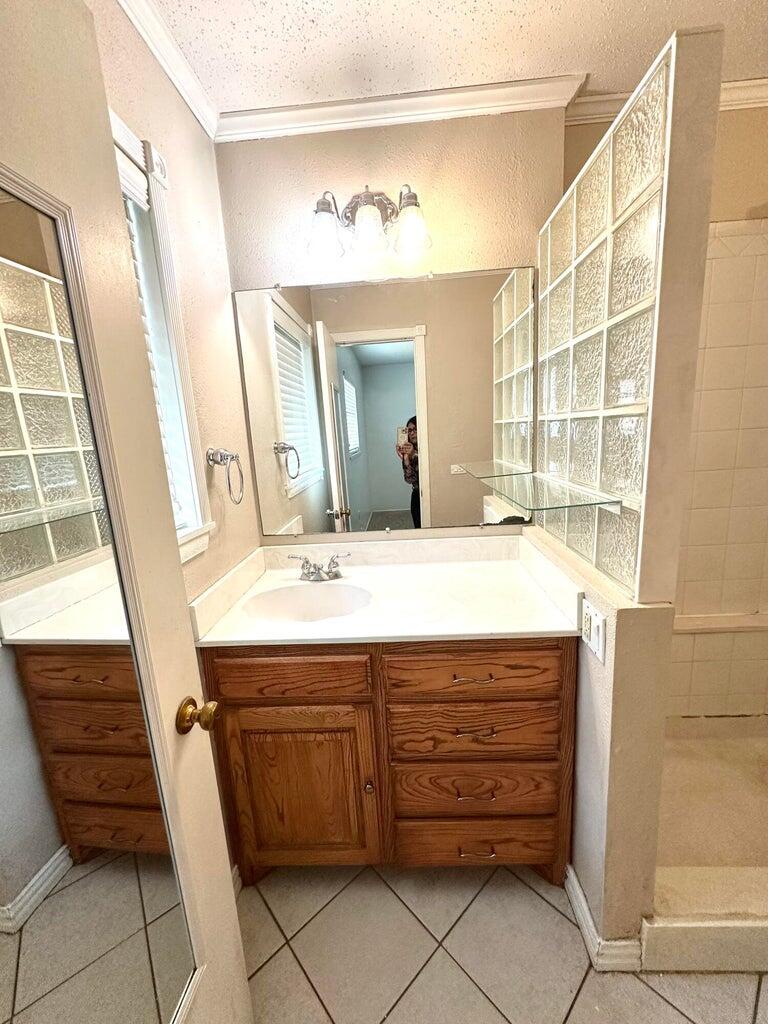 2615 West 19th Plainview, TX 79072 - Photo 7 of 15 a bathroom with a sink and a mirror
