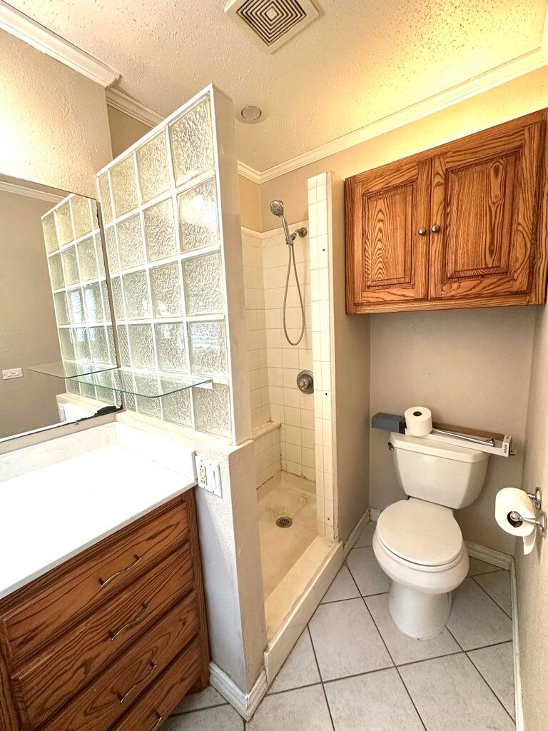 2615 West 19th Plainview, TX 79072 - Photo 8 of 15 a bathroom with a toilet a sink and a shower