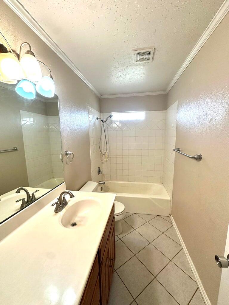 2615 West 19th Plainview, TX 79072 - Photo 10 of 15 a bathroom with a sink a large mirror and a shower