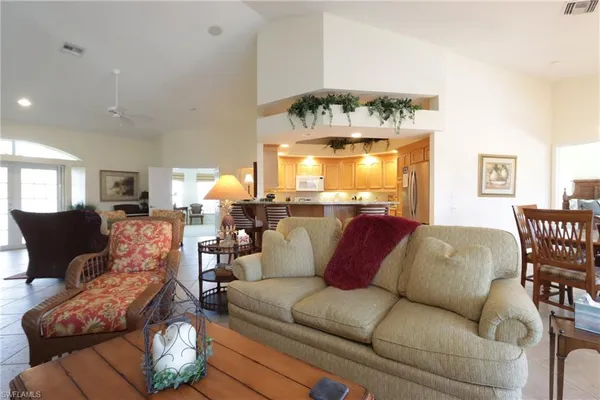 a living room with furniture fireplace and dining table