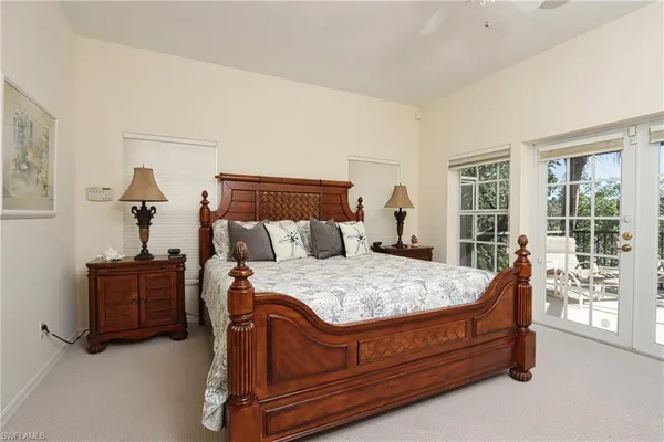 a bed sitting in a bedroom next to a window