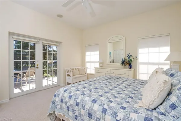 a bedroom with a large bed and a large window