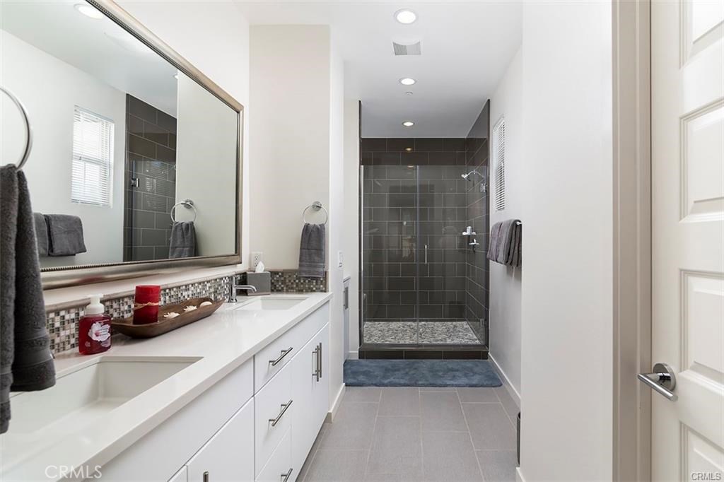 88 Agave Lake Forest, CA 92630 - Photo 17 of 26 a bathroom with a double vanity sink mirror and shower