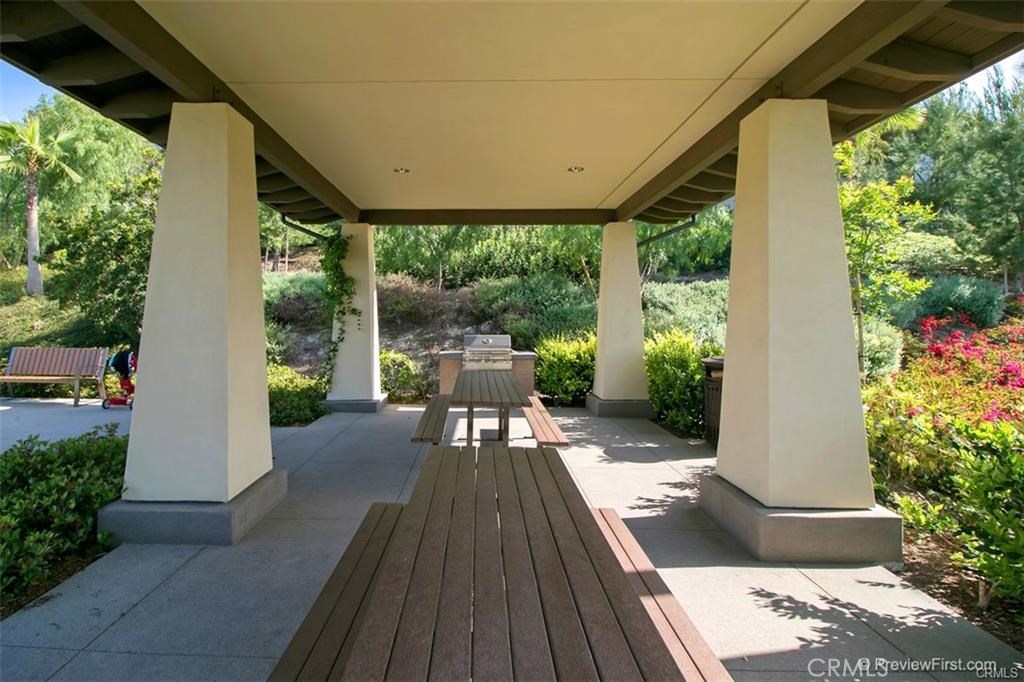 88 Agave Lake Forest, CA 92630 - Photo 25 of 26 a view of a patio with table and chairs potted plants and floor to ceiling window