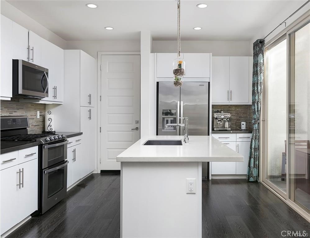 88 Agave Lake Forest, CA 92630 - Photo 4 of 26 a kitchen with stainless steel appliances kitchen island granite countertop a stove a sink and a refrigerator