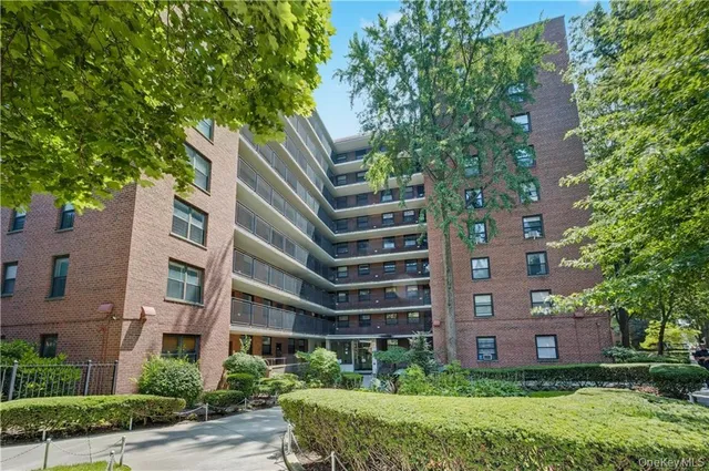 a front view of a building with garden