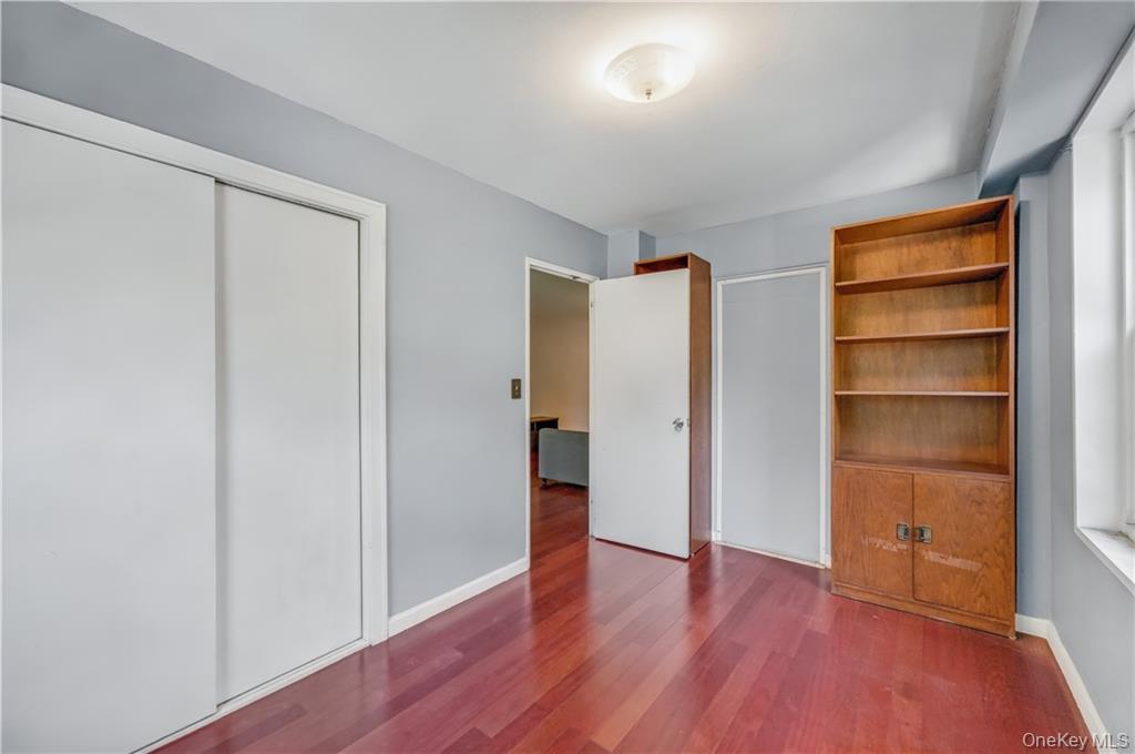 35-11 85th Street, Unit 3H Queens, NY 11372 - Photo 11 of 27 a view of an empty room with closet and wooden floor