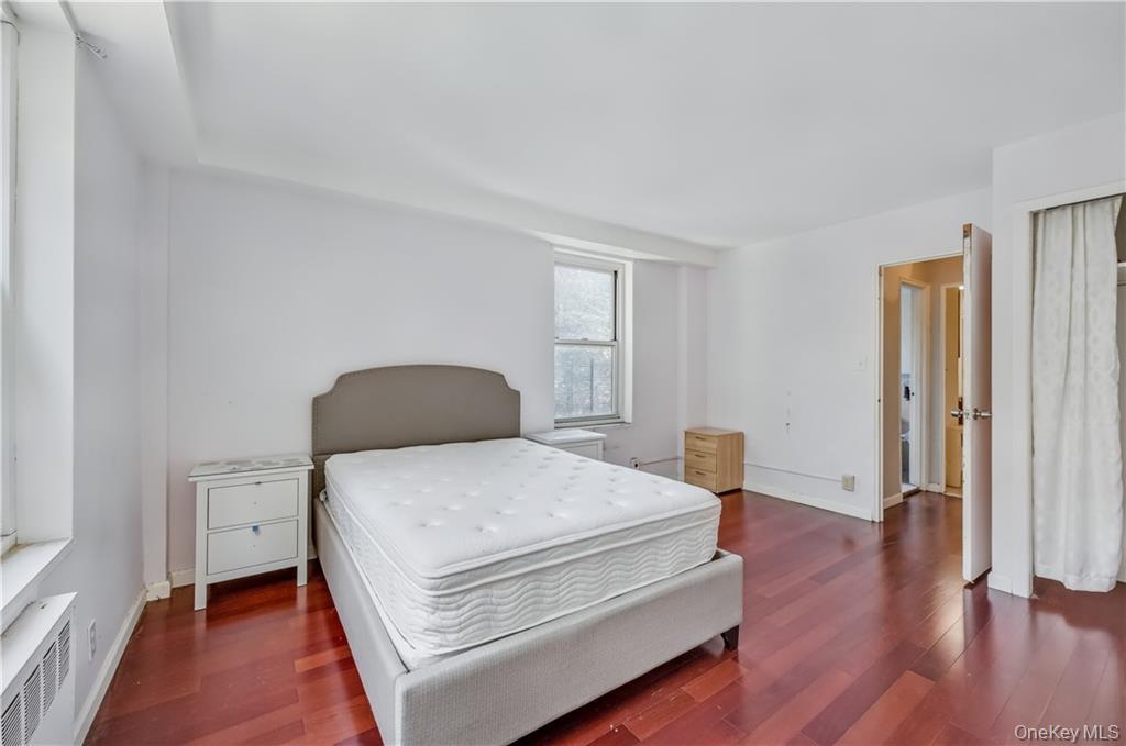 35-11 85th Street, Unit 3H Queens, NY 11372 - Photo 13 of 27 a bedroom with a bed and wooden floor