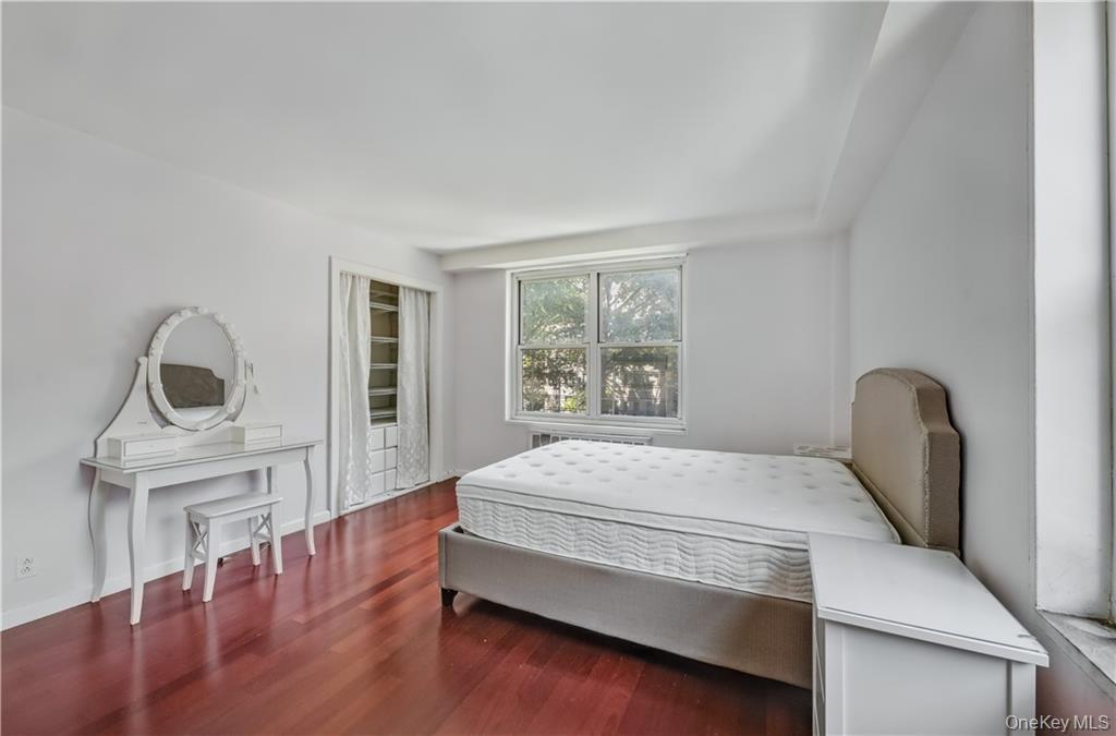 35-11 85th Street, Unit 3H Queens, NY 11372 - Photo 15 of 27 a bedroom with a bed chair and a window