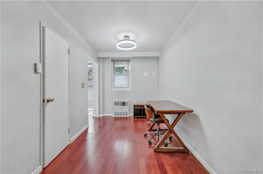 35-11 85th Street, Unit 3H Queens, NY 11372 - Photo 16 of 27 a view of a room with wooden floor air conditioner and a window