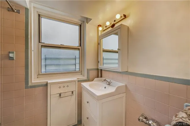 a bathroom with a sink mirror and vanity
