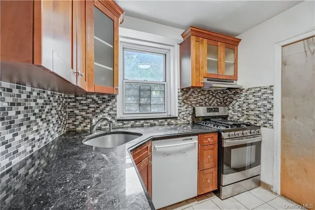 a kitchen with a sink stove and cabinets
