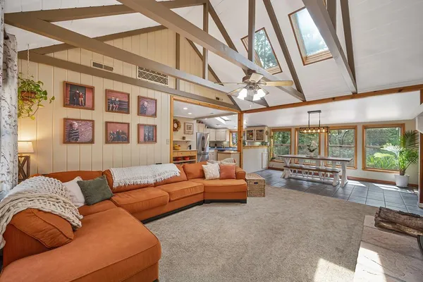 a living room with fireplace furniture and a flat screen tv