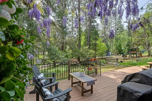 a backyard of a house with wooden floor and outdoor seating