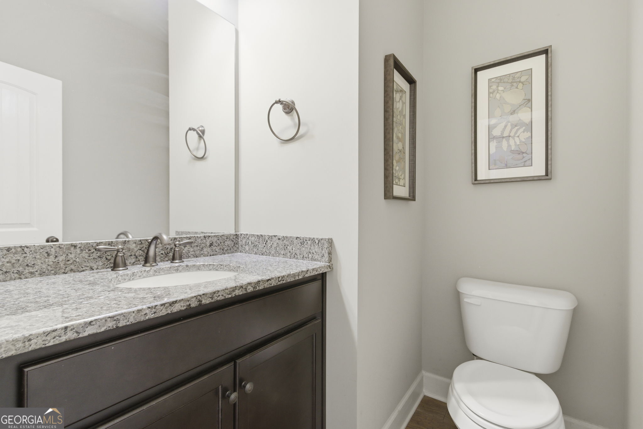 127 Austin Storey Circle Newnan, GA 30263 - Photo 13 of 34 a bathroom with a granite countertop toilet sink and mirror