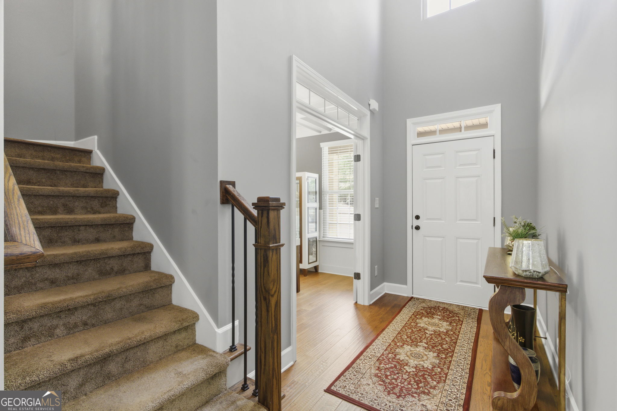 127 Austin Storey Circle Newnan, GA 30263 - Photo 14 of 34 a view of an entryway with wooden floor and a livingroom