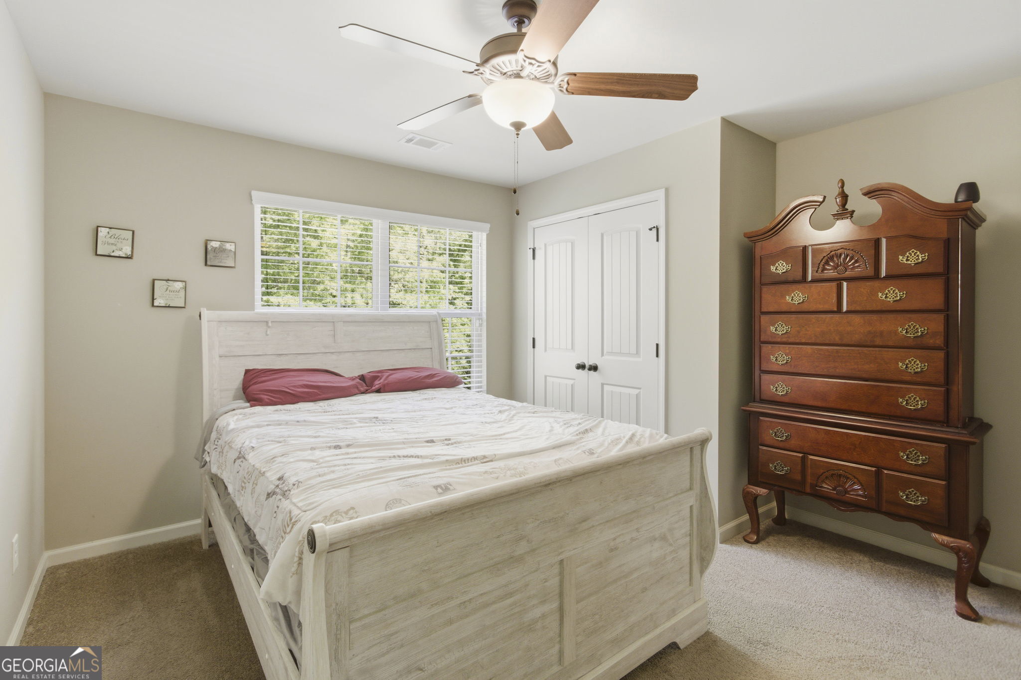 127 Austin Storey Circle Newnan, GA 30263 - Photo 27 of 34 a bedroom with a bed and a chandelier