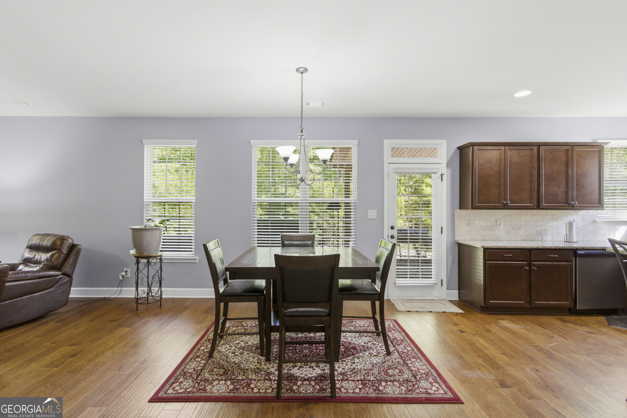 127 Austin Storey Circle Newnan, GA 30263 - Photo 8 of 34 a dining room with furniture a chandelier and wooden floor
