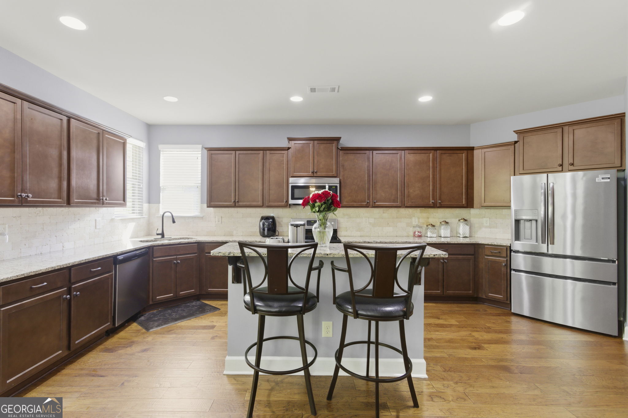 127 Austin Storey Circle Newnan, GA 30263 - Photo 10 of 34 a kitchen with granite countertop a center island stainless steel appliances cabinets and a counter top space