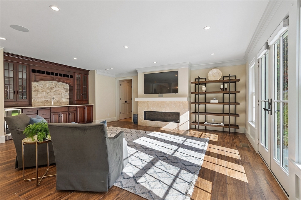 18 South Shaker Road Harvard, MA 01451 - Photo 12 of 42 a living room with furniture a flat screen tv and a floor to ceiling window