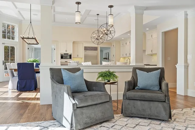 a living room with furniture and a chandelier