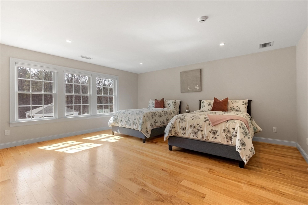 18 South Shaker Road Harvard, MA 01451 - Photo 31 of 40 a spacious bedroom with a bed and wooden floor